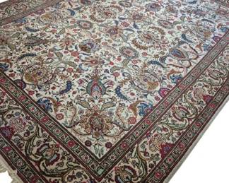 314 - Large Persian Style Area Rug 168"x118" (Description): Large Persian style area rug featuring an  allover paisley and floral design on a cream  ground. The field is filled with curving  boteh motifs and flowering vines in shades of  blue, red, green, and gold. Multiple decorative borders frame the central fi