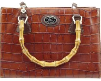 1785 - Dooney & Bourke Croc Embossed Handbag (Description): Dooney & Bourke croc embossed handbag  featuring bamboo handles and silver-tone  hardware. Measures 8 inches by 11 inches by 5  inches.