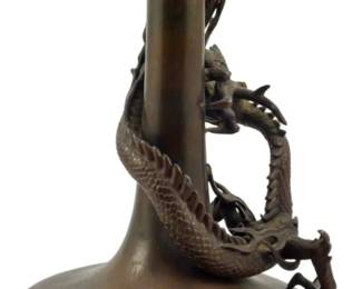 186 - Meiji Period Bronze Japanese Vase w/ Base 11" (Description): A Meiji period Japanese bronze vase featuring  an applied dragon design wrapping around the  elongated neck. The vase has a bulbous body  with a flared trumpet rim and rests on a  carved wooden base. Measures 11 inches in height.