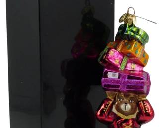 2501 - Christopher Radko Monkey Ornament 9" (Description): Christopher Radko monkey ornament featuring a  whimsical monkey figure carrying stacked  gift boxes. The ornament measures 9 inches  and comes with its original Christopher Radko  box.