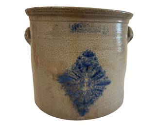 549 - F.H. Cowden Harrisburg PA 5 Gal Crock (Description): A 5-gallon stoneware crock by F.H. Cowden of  Harrisburg, Pennsylvania. This antique crock  features a salt-glazed finish with a cobalt  blue stenciled floral decoration in a diamond  shape on the front. The crock has applied lug handles on either side and impressed  maker's marks at the rim. Measures 11.5" x  13.5".