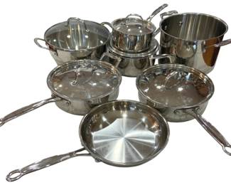 913 - Cuisinart Stainless Steel Pot & Pan Set (Description): Cuisinart stainless steel cookware set  comprising multiple pots and pans with glass  lids. The collection includes saucepans, a  stockpot, saute pans, and skillets in various  sizes, all featuring polished stainless steel construction with riveted handles.  Several pieces include tempered glass lids  with stainless steel rims and loop handles.