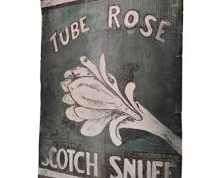 3754 - Tube Rose Scotch Snuff Cardboard Ad (Description): Vintage Tube Rose Scotch Snuff advertisement  on cardboard. This advertising piece features  a green background with white lettering and  a central tuberose flower graphic. The sign  shows weathering and patina consistent with age. Measures 45 inches by 29.5 inches.