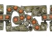 1935 - Orange Coral Cabochon Metal Bracelet (Description): An orange coral and cabochon metal bracelet  featuring decorative metalwork with coral  stone accents throughout the linked design.