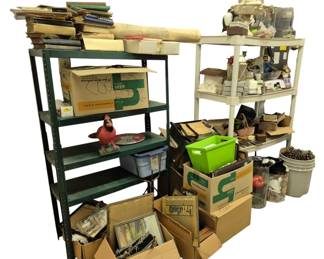 4168 - 2 Shelves w/ Contents (Description): Two shelving units sold with all contents  included. The lot features a green metal  shelving unit and a white shelving unit, both  filled with assorted items and boxes.