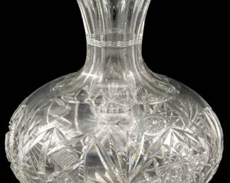 132 - American Brilliant Cut Glass Water Bottle (Description): American Brilliant cut glass water bottle  featuring intricate cut patterns. Measures  7.5 inches in height.