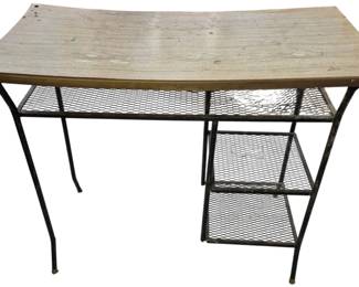 4137 - Mid-Century Table 30"x36.5"x18.5" (Description): Mid-Century Modern table featuring a wooden  top with black metal frame and mesh wire  shelving on one side. Measures 30" x 36 1/2"  x 18.5".