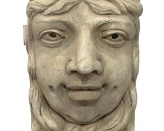 941 - Figural Wall Corbel (Description): Antique carved wood figural wall bracket  featuring a decorative face with flowing hair  and ornate scrollwork crown. The piece  displays a whitewashed or limed finish with a  classical aesthetic, likely designed as an architectural element or decorative shelf  support. Measures 13" x 9" x 9".