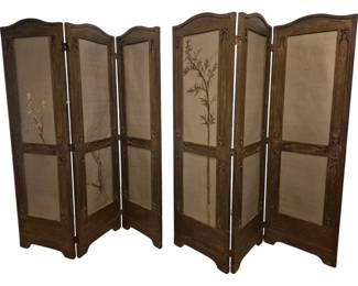 3774 - Matched Pair of Oriental Three-Panel Screens (Description): Matched pair of Oriental folding screens,  each featuring three panels within carved  wooden frames. The screens display delicate  hand-painted botanical motifs on fabric  panels, with one screen depicting a cherry blossom branch and the other featuring  bamboo. The dark-stained wooden frames  feature an arched top design and decorative  carved accents at the panel intersections.  Each panel measures 63" x 19".