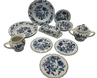 1248 - Assorted Blue Danube Blue Onion Dinnerware (Description): Assorted Blue Danube blue onion pattern  dinnerware pieces. This collection includes  plates in various sizes, a covered sugar  bowl, a creamer, a covered butter dish, and  small dishes. Each piece features the classic blue onion floral motif on white porcelain  with scalloped edges.