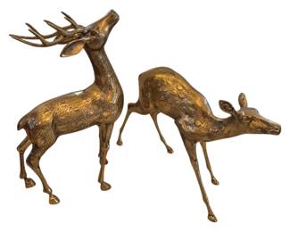 1462 - Pr Brass Deer Figurines Buck & Doe 18"x4"x11" (Description): Pair of brass deer figurines featuring a stag  with raised head and full antlers alongside  a graceful doe. Both pieces display textured  surfaces with decorative spotted detailing  and an antiqued golden patina finish. The elegant sculptures capture the deer in  naturalistic poses on slender legs.
