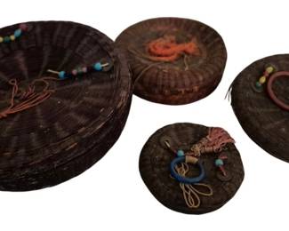 4171 - 4 Vintage Woven Baskets (Description): A collection of four vintage woven baskets  with decorative beaded accents and tassels.  The baskets feature traditional dark woven  construction with colorful embellishments.  Some damage.