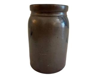 578 - Antique Salt Glazed Stoneware Crock 10"x6" (Description): Antique salt glazed stoneware crock featuring  cobalt blue decorative brushwork near the  shoulder. The piece displays a classic rolled  rim and cylindrical form typical of 19th  century American stoneware. The body shows a warm brown salt glaze finish with natural  variations. Measures 10 inches tall by 6  inches in diameter.