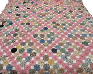 1270 - Vtg Handmade Yo-Yo Quilt Pink Multi-Color (Description): Vintage handmade yo-yo quilt featuring  hundreds of gathered fabric circles  hand-stitched together in a traditional  pattern. The design incorporates a  predominantly pink color scheme with a border of solid pink yo-yos surrounding a  multicolored center section. The interior  displays a charming variety of printed and  solid fabrics in colors including blue,  green, yellow, brown, cream, and floral