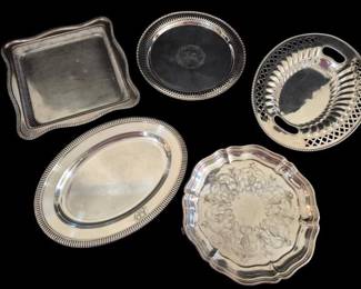 520 - Five Assorted Silver Plated Serving Trays (Description): Rogers silver plate ice bucket with lid,  measuring 14 inches tall. This elegant piece  features a swing handle with decorative  finial attachments, a fitted domed lid with  matching finial, and stands on four ornate claw feet. The bucket has a classic round  form with clean lines typical of mid-century  barware design. Complete with removable  insulated liner for keeping ice cold during  entertaining.