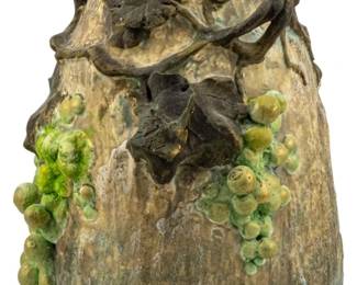 759 - Amphora Style Art Nouveau Vase Ca. 1900 9" (Description): Amphora style Art Nouveau vase, circa 1900.  The vase features sculptural grape vine and  leaf decorations in relief with green and  yellow glazed grape clusters against a  naturalistic mottled body. Measures 9 inches in height.