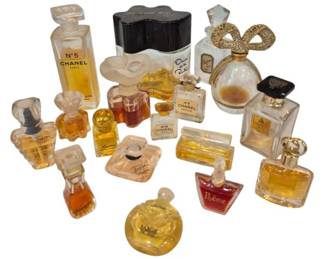 2709 - Group of Designer Miniature Perfume Bottles (Description): A collection of designer miniature perfume  bottles featuring notable brands including  Chanel No. 5, Oscar de la Renta, Lancome  Trejor, Lauren by Ralph Lauren, Poeme and  others. The group includes approximately 18 bottles in various sizes and style, some with  decorative caps and original perfume  contents. The bottles showcase a range of  classic and contemporary designs from  prestigious fragrance houses.