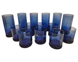 2721 - 14 Octagonal Blue Glass Tumblers 7"+4" (Description): A set of fourteen octagonal blue glass  tumblers comprising two sizes. The collection  includes taller highball glasses measuring 7  inches and shorter old fashioned glasses  measuring 4 inches. Each tumbler features an elegant octagonal shape with a rich cobalt  blue coloring and a solid footed base.