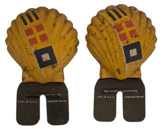 2780 - 2 Vtg Shell Oil Advertising License Toppers (Description): Pair of vintage Shell Oil advertising license  plate toppers. Each features the iconic  yellow scallop shell design with nautical  signal flag motifs in red, yellow, blue, and  black. The metal bases are marked "Made in U.S.A." and "Patent No. 1,902,4." The pieces  show age-appropriate wear consistent with  use, displaying a weathered patina on the  yellow painted surfaces.