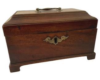 399 - English Tea Caddy 9"x5"x6" (Description): English tea caddy crafted in mahogany with a  rich, warm patina. Features a hinged lid with  brass bail handle, decorative brass  escutcheon plate, and bracket feet. The caddy  displays classic Georgian styling with its rectangular form and molded base.