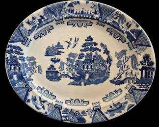 514 - Johnson Bros Blue Willow Oval Platter (Description): Oval platter features Johnson Bros Blue  Willow pattern with pagodas, bridges, willow  trees, and birds in a traditional chinoiserie  design, measuring 16.5" x 14".