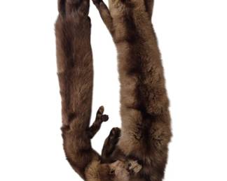 1301 - Mink Fur Stole 48" (Description): A luxurious mink fur stole measuring 48  inches in length. This vintage stole features  two full pelts with natural brown coloring,  complete with heads, tails, and paws intact.  The pelts are designed to drape elegantly around the shoulders, characteristic of  mid-century fur fashion accessories.
