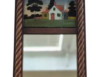 626 - Reverse Painted Mirror 22.5" x 13" (Description): Reverse painted wall mirror featuring  decorative painted glass panel above the main  mirror section. The frame showcases  traditional woodwork design with carved rope  twist columns flanking the mirror.