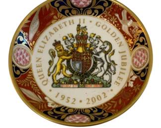 382 - Queen Elizabeth II Golden Jubilee Dish 4.5" (Description): A commemorative dish celebrating Queen  Elizabeth II's Golden Jubilee, marking the  years 1952-2002. The dish features the Royal  Coat of Arms at center with the motto "Dieu  et Mon Droit," surrounded by an ornate border with floral motifs and gilt accents.  Measures 4.5 inches in diameter.