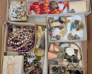 2777 - Vintage Costume Jewelry Lot (Description): Assortment includes multiple necklaces in  various styles and colors, including black  beaded strands, orange geometric beads, pink  and purple beaded strands, and chain  necklaces. Also included are numerous pairs of clip-on earrings in assorted styles,  several brooches and pins, and other  decorative accessories.