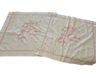 1297 - Pr Vtg Redwork Embroidered Linens 27 x 28 (Description): Pair of vintage redwork embroidered pillow  shams featuring a charming 'Good Night'  design with a figure and floral motifs. The  cream-colored cotton shams display decorative  red zigzag stitching along the borders. Some staining.