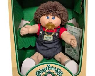 4160 - Cabbage Patch Kids Elmer Terry Doll (Description): Cabbage Patch Kids doll named Elmer Terry.  This classic CPK doll features the  characteristic soft-sculpted design that made  these collectible dolls famous. Includes  original packaging and birth certificate documentation.