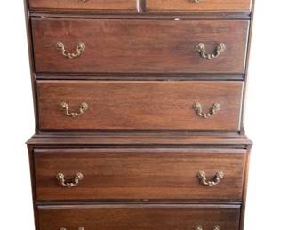 1360 - Mahogany Chest on Chest 54"x35"x20" (Description): A classic chest on chest featuring multiple  drawers with ornate brass bail pulls. The  piece rests on bracket feet with decorative  carved detailing along the base.