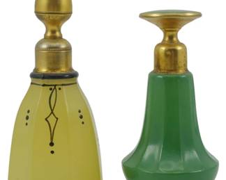 860 - 2 Vintage Perfume Bottles 4.5" (Description): Two vintage perfume bottles, each measuring  4.5 inches in height. The collection features  decorative glass bottles with ornate  gilt-toned stoppers, showcasing classic  vanity styling.