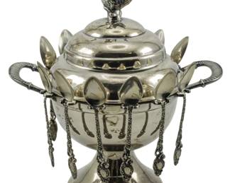 88 - Rogers Quadruple Plate Sugar Bowl w/ Spoons (Description): Rogers quadruple plate sugar bowl with lid  featuring a figural bird finial. The bowl is  accompanied by ten decorative spoons that  rest in slots around the rim, with ornamental  chains hanging from the body. Measures 9 inches.