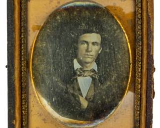 198 - Ninth Plate Daguerreotype of Man 2.5"x2" (Description): A ninth plate daguerreotype portrait of a  man, presented in its original case with  brass mat and decorative frame. The image  measures 2 1/2" x 2".