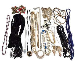 1993 - Collection of 16 Assorted Costume Necklaces (Description): A collection of 16 assorted costume necklaces  featuring a variety of styles and materials.  The grouping includes black beaded statement  necklaces with fringe details, gold-tone  chain necklaces in various link styles, faux pearl strands, a purple glass bead necklace,  colorful beaded necklaces with natural stone  and glass beads, shell pendant necklaces, a  dark blue braided cord necklace, and pieces  with decorative clasps and pendants.