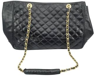 1829 - Capica Quilted Leather Tote Bag 10"x16"x3" (Description): Capica quilted leather tote bag featuring  gold-tone chain straps interwoven with  leather. The bag showcases classic diamond  quilting on the front panel with smooth  leather side panels. Measures 10 inches high by 16 inches wide by 3 inches deep.