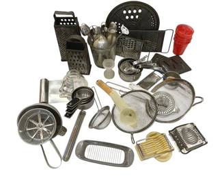 1251 - Vtg Kitchenware Graters Strainers & Utensils (Description): A collection of vintage kitchenware including  multiple box graters, flat graters, mesh  strainers of various sizes, measuring cups,  egg slicers, a food mill, stainless steel  utensils in a glass holder, a splatter screen, butter dish, and red plastic  tumblers. The assortment features  predominantly stainless steel and aluminum  pieces with some plastic components,  representing mid-century kitchen tools and