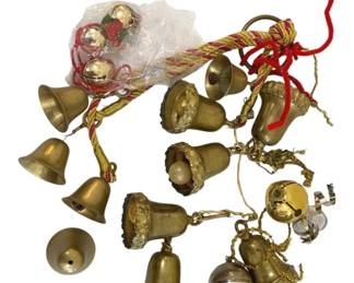 363 - Group Lot of Bells (Description): A group lot of bells in various sizes and  styles. The collection includes multiple  brass-toned bells with decorative details,  some featuring ornamental bands and  holiday-themed embellishments. Several bells are strung together on decorative cord.