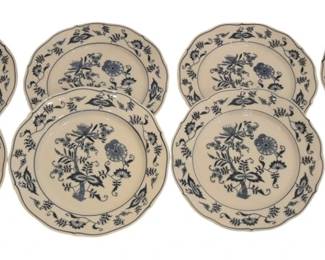 1245 - 8 Blue Danube Blue Onion 8.5" Plates (Description): A set of Blue Danube porcelain plates in the  classic Blue Onion pattern. The plates  feature traditional cobalt blue floral and  botanical motifs on a white ground, with  scalloped edges trimmed in blue. The collection includes dinner plates and smaller  plates, all displaying the characteristic  onion pattern design with central floral  medallions and decorative borders.