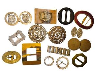1471 - Group Vintage Belt Buckles (Description): A collection of vintage belt buckles in  assorted styles and materials. The group  includes ornate filigree gilt metal buckles  with scrollwork designs, rhinestone-set  circular buckles, tortoiseshell-look Bakelite buckles, silvered engraved metal examples,  and marbled celluloid pieces. Various shapes  represented include oval, round, rectangular,  and hexagonal forms. An attractive  assemblage showcasing mid-century fashion