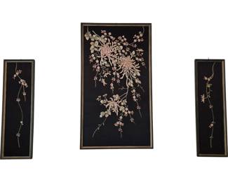 3703 - 3 Pc Asian Floral Embroidered Silk Panels (Description): Three-piece Asian-inspired art set featuring  floral embroidery on black silk fabric  mounted over plywood and presented in  coordinating frames. The collection includes  one large central panel with an elaborate chrysanthemum and peony arrangement with  cascading blossoms and foliage, flanked by  two smaller vertical panels depicting  delicate trailing cherry blossom branches.  The embroidery displays soft pink, cream, and