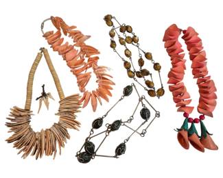 1995 - Collection of 5 Artisan Style Necklaces (Description): A collection of five necklaces featuring  various artisan and bohemian styles. The  grouping includes a natural bone or shell  disc necklace with tooth-like pendants, an  orange-coral toned shell or mother of pearl petal necklace, a wire-linked necklace with  amber-colored glass beads and dark green  marbled stones, and a coral-pink sculptural  necklace with decorative pepper or floral  pendant accents. The pieces showcase organic