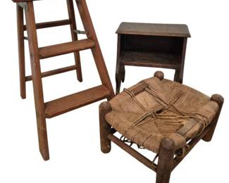 3710 - Vintage Wooden Stools and Step Ladder (Description): A collection of three vintage wooden seating  and step pieces. The group includes a folding  wooden step ladder with a flat top platform,  a small wooden bench or stool with a lower  shelf, and a rustic footstool with a woven rush seat in a crossed pattern. All pieces  show natural wear consistent with age and  use.