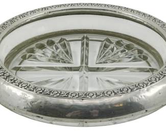 74 - Rogers Silver Co Sterling & Glass Bottle Coaster (Description): Rogers Silver Co sterling silver and glass  bottle coaster featuring a decorative floral  border on the sterling rim with a cut glass  insert. Measures 1.5 inches tall by 6.5  inches in diameter.