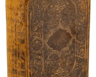 827 - 1871 Edition The Holy Bible (Description): An 1871 edition of The Holy Bible. The volume  features an embossed decorative cover with  ornate scrollwork patterns and a central  medallion design. The binding shows  age-appropriate wear consistent with a book of this era.