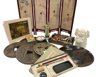 956 - Asian Decorative Arts Collection (Description): A diverse collection of Asian decorative arts  including a four-panel folding screen  depicting women in traditional dress with  painted landscape backgrounds, a porcelain  figure of a person in traditional Chinese attire, a white ceramic figure, oversized  decorative coins with Chinese characters, a  metal dragon plaque, a lacquered plate with  wave design, a calligraphy set with brushes  and ink stone in original box, a small