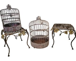 3742 - 4 Metal Items: 2 Birdcages & Plant Stands (Description): Metal decorative items including two domed  decorative birdcages with distressed white  finish featuring leaf motifs, accompanied by  a pair of ornate plant stands with lattice  tops and decorative grapevine and leaf embellishments on cabriole-style legs.