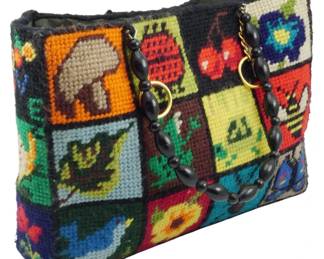1821 - Vintage Needlepoint Nature Sampler Tote (Description): Vintage needlepoint nature sampler tote  featuring colorful stitched panels with  various nature motifs. The bag has beaded  handles with gold-tone hardware. Measures 10  inches wide by 13 inches tall by 3 inches deep.