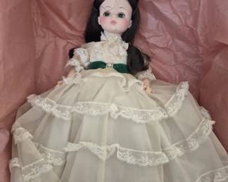 1392 - Madame Alexander Scarlett #1590 Doll 13" (Description): Scarlett doll, model #1590. This collectible  doll features dark hair with a green velvet  bodice and an elaborate cream-colored  lace-trimmed gown. Measures 13 inches tall.